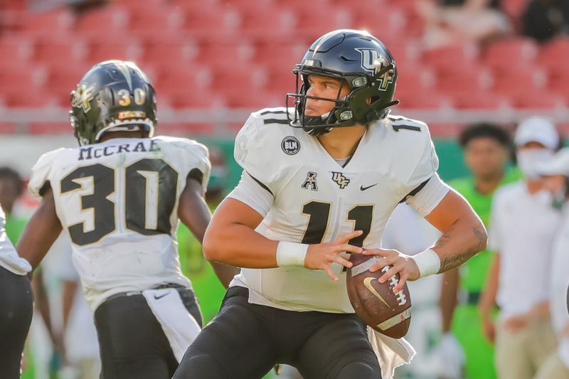 Nov 27, 2020; Tampa, Florida, USA; UCF Knights quarterback Dillon Gabriel (11) passes the ball during the first quarter against the South Florida Bulls at Raymond James Stadium. Mandatory Credit: Mike Watters-USA TODAY Sports