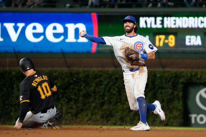 Sep 3, 2024; Chicago, Illinois, USA; Chicago Cubs shortstop Dansby Swanson (7) forces out Pittsburgh Pirates outfielder Bryan Reynolds (10) at second base during the third inning at Wrigley Field. Mandatory Credit: David Banks-Imagn Images