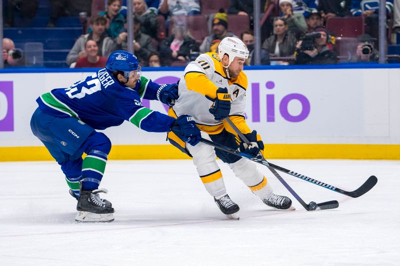 Nov 17, 2024; Vancouver, British Columbia, CAN; Vancouver Canucks forward Teddy Blueger (53) stick checks Nashville Predators forward Ryan O'Reilly (90) during the second period at Rogers Arena. Mandatory Credit: Bob Frid-Imagn Images