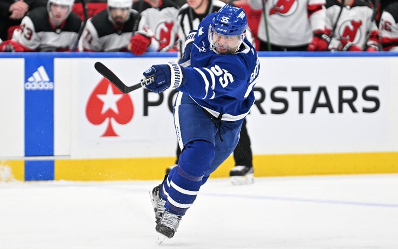 Apr 11, 2024; Toronto, Ontario, CAN; Toronto Maple Leafs defenseman Mark Giordano (55) shoots the puck against the New Jersey Devils in the first period at Scotiabank Arena. Mandatory Credit: Dan Hamilton-USA TODAY Sports