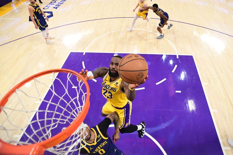 LOS ANGELES, CA - APRIL 9: LeBron James #23 of the Los Angeles Lakers drives to the basket during the game against the Golden State Warriors on April 9, 2024 at Crypto.Com Arena in Los Angeles, California. NOTE TO USER: User expressly acknowledges and agrees that, by downloading and/or using this Photograph, user is consenting to the terms and conditions of the Getty Images License Agreement. Mandatory Copyright Notice: Copyright 2024 NBAE (Photo by Adam Pantozzi/NBAE via Getty Images)