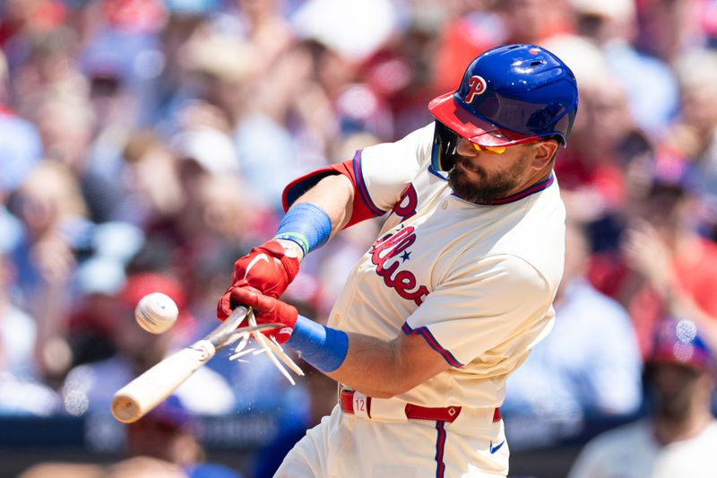 May 8, 2024; Philadelphia, Pennsylvania, USA; Philadelphia Phillies designated hitter Kyle Schwarber (12) breaks his bat while hitting an RBI sacrifice fly against the Toronto Blue Jays during the third inning at Citizens Bank Park. Mandatory Credit: Bill Streicher-USA TODAY Sports