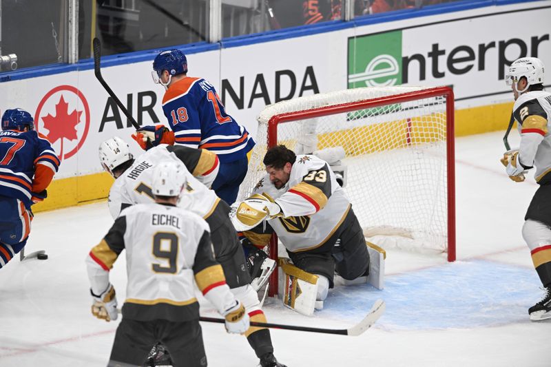 May 10, 2025; Edmonton, Alberta, CAN; Edmonton Oilers left winger Zach Hyman (18) skates past Vegas Golden Knights goalie Adin Hill (33) as his helmet flies off during the second period in game three of the second round of the 2025 Stanley Cup Playoffs at Rogers Place. Mandatory Credit: Walter Tychnowicz-Imagn Images