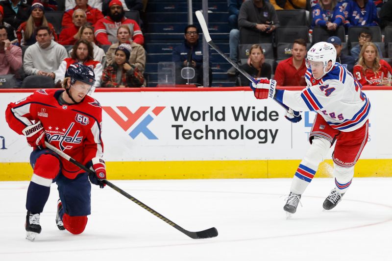 Oct 29, 2024; Washington, District of Columbia, USA; New York Rangers right wing Kaapo Kakko (24) shoots the puck as Washington Capitals defenseman Rasmus Sandin (38) defends in the third period at Capital One Arena. Mandatory Credit: Geoff Burke-Imagn Images