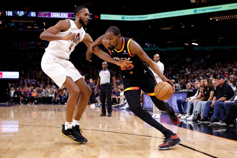 PHOENIX, ARIZONA - APRIL 03: Kevin Durant #35 of the Phoenix Suns drives against Evan Mobley #4 of the Cleveland Cavaliers during the second half at Footprint Center on April 03, 2024 in Phoenix, Arizona. NOTE TO USER: User expressly acknowledges and agrees that, by downloading and or using this photograph, User is consenting to the terms and conditions of the Getty Images License Agreement.  (Photo by Chris Coduto/Getty Images)