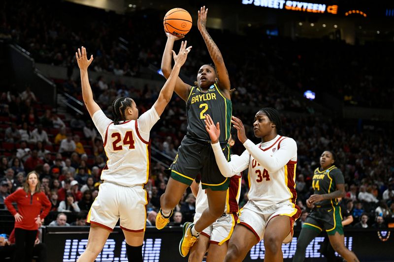 Mar 30, 2024; Portland, OR, USA; Baylor Lady Bears guard Yaya Felder (2) shoots a basket during the first half against USC Trojans forward Kaitlyn Davis (24) and center Clarice Akunwafo (34) in the semifinals of the Portland Regional of the 2024 NCAA Tournament at the Moda Center. Mandatory Credit: Troy Wayrynen-USA TODAY Sports