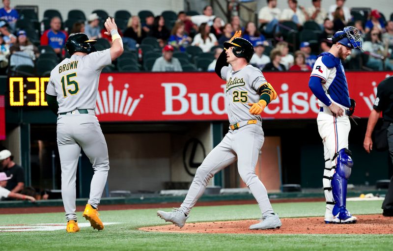 Apr 30, 2025; Arlington, Texas, USA;  Oakland Athletics designated hitter Brent Rooker (25) celebrates with left fielder Seth Brown (15) after hitting a two-run home run during the ninth inning against the Texas Rangers at Globe Life Field. Mandatory Credit: Kevin Jairaj-Imagn Images