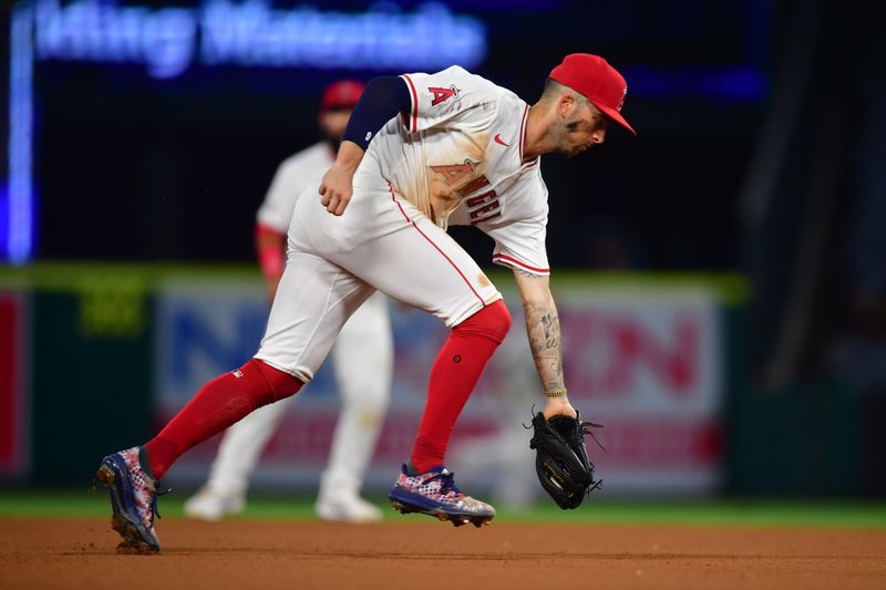 Jun 25, 2024; Anaheim, California, USA; Los Angeles Angels shortstop Zach Neto (9) fields the ground ball of Oakland Athletics designated hitter Brent Rooker (25) during the ninth inning at Angel Stadium. Mandatory Credit: Gary A. Vasquez-USA TODAY Sports