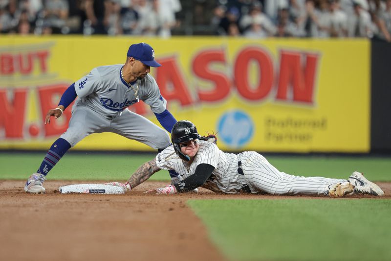 Jun 8, 2024; Bronx, New York, USA; New York Yankees left fielder Alex Verdugo (24) dives safely in to second base beating the tag by Los Angeles Dodgers shortstop Mookie Betts (50) during the fifth inning at Yankee Stadium. Mandatory Credit: Vincent Carchietta-USA TODAY Sports