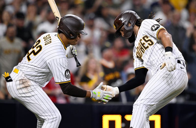 Sep 5, 2023; San Diego, California, USA; San Diego Padres right fielder Fernando Tatis Jr. (right) celebrates with left fielder Juan Soto (22) after hitting a home run against the Philadelphia Phillies during the fourth inning at Petco Park. Mandatory Credit: Orlando Ramirez-USA TODAY Sports