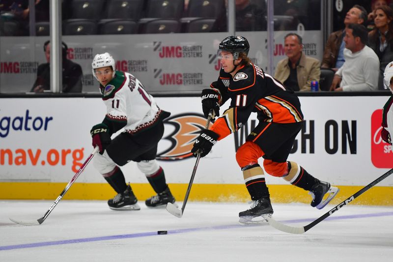 Oct 5, 2023; Anaheim, California, USA; Anaheim Ducks center Trevor Zegras (11) moves the puck against Arizona Coyotes right wing Dylan Guenther (11) during the first period at Honda Center. Mandatory Credit: Gary A. Vasquez-USA TODAY Sports