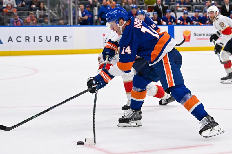 Oct 26, 2024; Elmont, New York, USA;  New York Islanders center Bo Horvat (14) attempts a shot against the Florida Panthers during the second period at UBS Arena. Mandatory Credit: Dennis Schneidler-Imagn Images