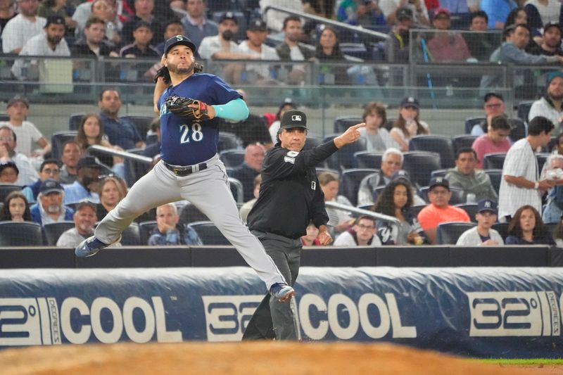 Jun 22, 2023; Bronx, New York, USA; Seattle Mariners third baseman Eugenio Suarez (28) throws out a runner at second base after fielding a ground ball hit by New York Yankees third baseman Josh Donaldson (not pictured) during the fourth inning at Yankee Stadium. Mandatory Credit: Gregory Fisher-USA TODAY Sports