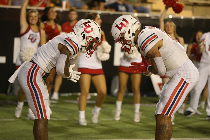 Sep 3, 2022; Hattiesburg, Mississippi, USA; Liberty Flames wide receivers Demario Douglas (3) and CJ Yarbrough (13) celebrate Douglas  touchdown catch in the second half against the Southern Miss Golden Eagles at M.M. Roberts Stadium. Liberty won in overtime, 29-27. Mandatory Credit: Chuck Cook-USA TODAY Sports