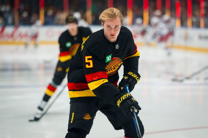 Oct 28, 2025; Vancouver, British Columbia, CAN; Making his NHL debut Vancouver Canucks defenseman Tom Willander (5) skates during warm up prior to a game against the New York Rangers at Rogers Arena. Mandatory Credit: Bob Frid-Imagn Images