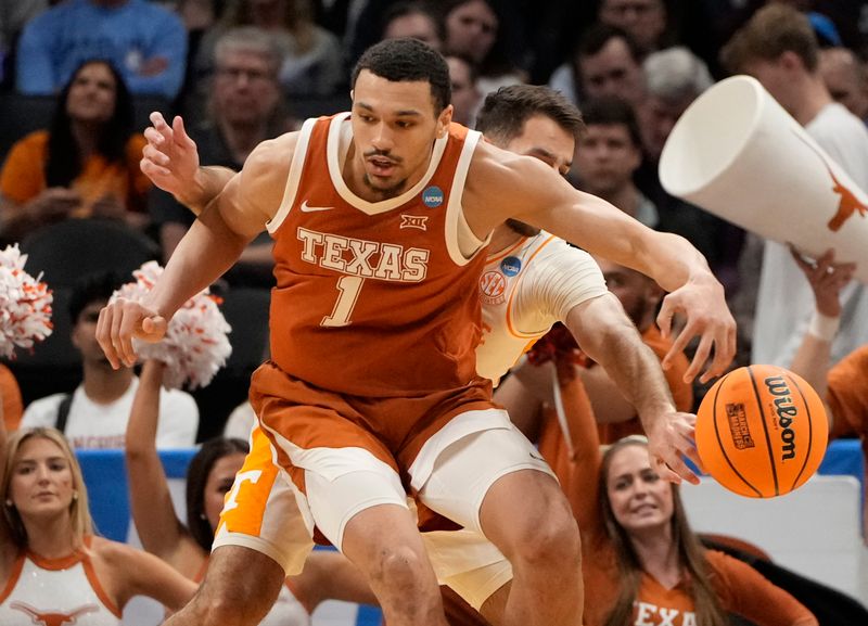 March 23, 2024, Charlotte, NC, USA; Tennessee Volunteers guard Santiago Vescovi (25) knocks the ball away from Texas Longhorns forward Dylan Disu (1) in the second round of the 2024 NCAA Tournament at the Spectrum Center. Mandatory Credit: Bob Donnan-USA TODAY Sports