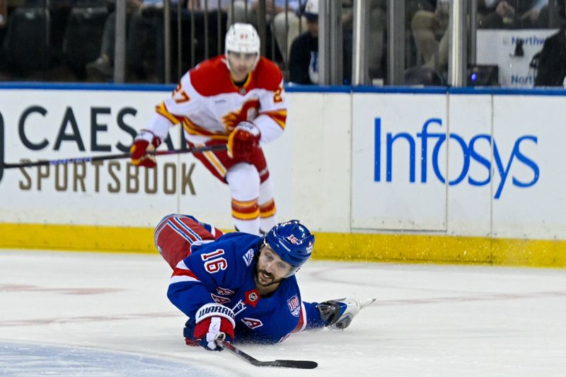Mar 10, 2026; New York, New York, USA;  New York Rangers center Vincent Trocheck (16) dives to play the puck against the Calgary Flames during the first period at Madison Square Garden. Mandatory Credit: Dennis Schneidler-Imagn Images