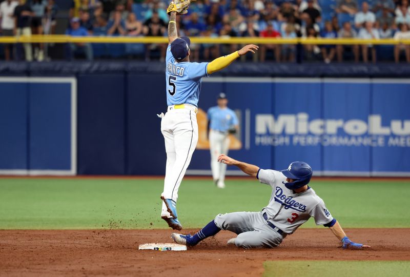 May 28, 2023; St. Petersburg, Florida, USA; Los Angeles Dodgers shortstop Chris Taylor (3) slides safe into second base as Tampa Bay Rays shortstop Wander Franco (5) attempted to catch the ball during the third inning  at Tropicana Field. Mandatory Credit: Kim Klement-USA TODAY Sports