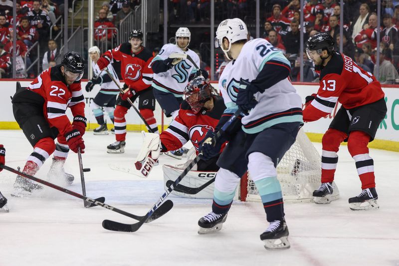 Dec 6, 2024; Newark, New Jersey, USA; New Jersey Devils defenseman Brett Pesce (22) and Seattle Kraken right wing Oliver Bjorkstrand (22) battle for the puck in front of New Jersey Devils goaltender Jacob Markstrom (25) during the third period at Prudential Center. Mandatory Credit: Ed Mulholland-Imagn Images