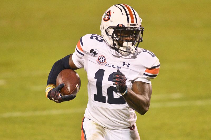 Dec 12, 2020; Starkville, Mississippi, USA;  Auburn Tigers wide receiver Eli Stove (12) runs the ball against the Mississippi State Bulldogs during the second quarter at Davis Wade Stadium at Scott Field. Mandatory Credit: Matt Bush-USA TODAY Sports