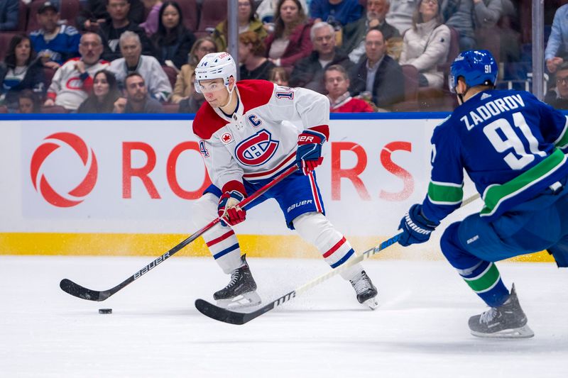 Mar 21, 2024; Vancouver, British Columbia, CAN; Vancouver Canucks defenseman Nikita Zadorov (91) watches Montreal Canadiens forward Nick Suzuki (14) handles the puck in the second period at Rogers Arena. Mandatory Credit: Bob Frid-USA TODAY Sports