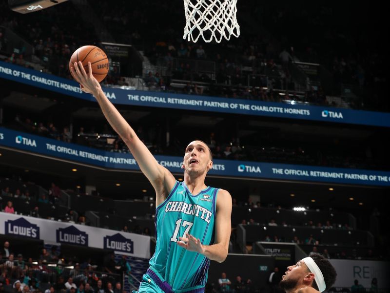 CHARLOTTE, NC - MARCH 15: Aleksej Pokusevski #17 of the Charlotte Hornets drives to the basket during the game against the Phoenix Suns on March 15, 2024 at Spectrum Center in Charlotte, North Carolina. NOTE TO USER: User expressly acknowledges and agrees that, by downloading and or using this photograph, User is consenting to the terms and conditions of the Getty Images License Agreement. Mandatory Copyright Notice: Copyright 2024 NBAE (Photo by Kent Smith/NBAE via Getty Images)
