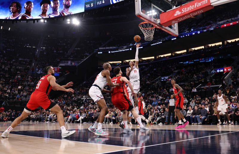 INGLEWOOD, CALIFORNIA - DECEMBER 08: Jordan Miller #11 of the Los Angeles Clippers scores a basket against Alperen Sengun #28 of the Houston Rockets during the first half at Intuit Dome on December 8, 2024 in Inglewood, California. NOTE TO USER: User expressly acknowledges and agrees that, by downloading and or using this photograph, User is consenting to the terms and conditions of the Getty Images License Agreement. (Photo by Kevork Djansezian/Getty Images)