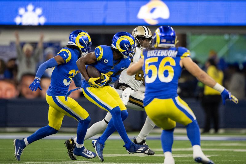 Los Angeles Rams safety Jordan Fuller (4) intercepts a pass intended to New Orleans Saints tight end Juwan Johnson (83) during an NFL football game, Thursday, Dec. 21, 2023, in Inglewood, Calif. (AP Photo/Kyusung Gong)