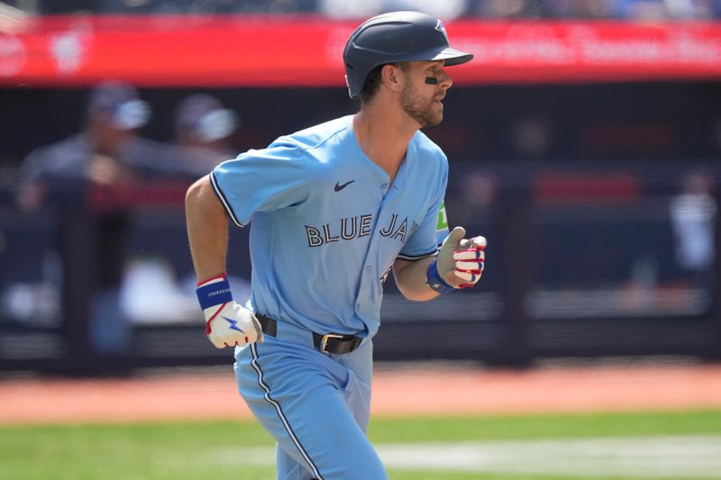 Jul 21, 2024; Toronto, Ontario, CAN; Toronto Blue Jays third baseman Ernie Clement (28) runs to first base on a RBI single against the Detroit Tigers during the sixth inning at Rogers Centre. Mandatory Credit: John E. Sokolowski-USA TODAY Sports