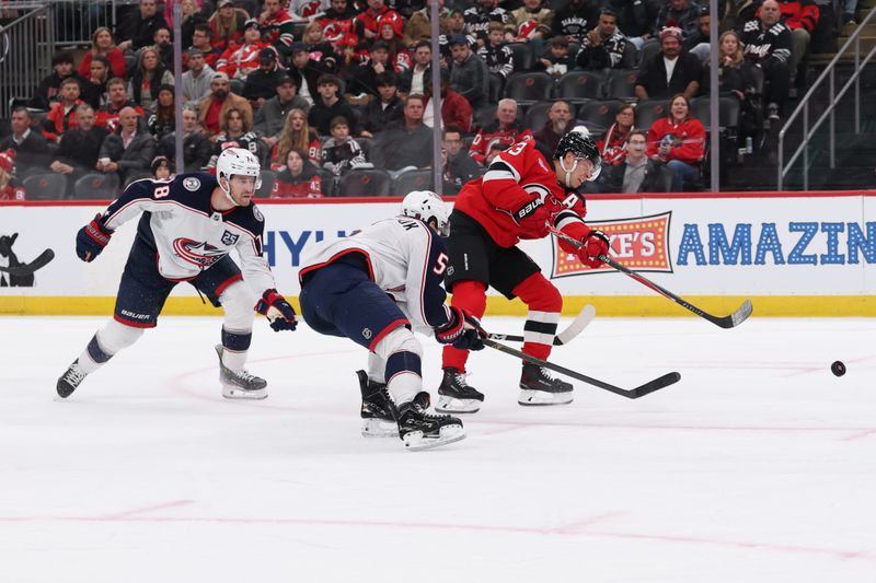Dec 1, 2025; Newark, New Jersey, USA; New Jersey Devils left wing Jesper Bratt (63) shoots the puck against the Columbus Blue Jackets during the second period at Prudential Center. Mandatory Credit: Ed Mulholland-Imagn Images