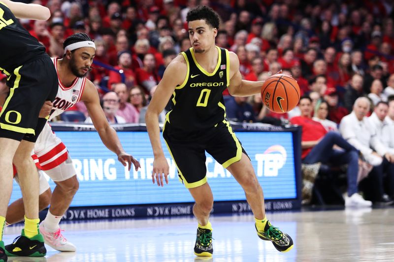 Feb 2, 2023; Tucson, Arizona, USA; Oregon Ducks guard Will Richardson (0) drives to the net against Arizona Wildcats guard Kylan Boswell (4) in the first half at McKale Center. Mandatory Credit: Zachary BonDurant-USA TODAY Sports