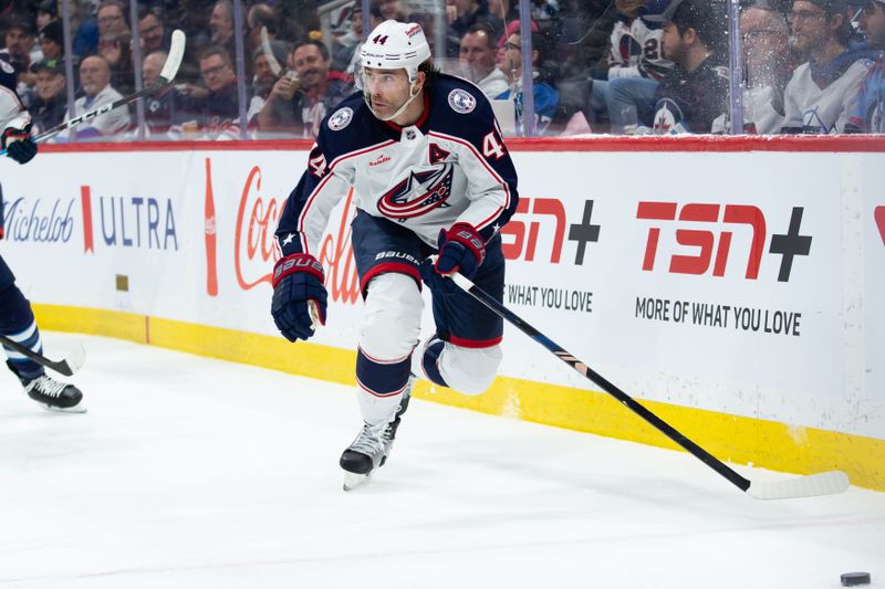 Jan 9, 2024; Winnipeg, Manitoba, CAN; Columbus Blue Jackets defenseman Erik Gudbranson (44) looks to make a play against the Winnipeg Jets during the first period at Canada Life Centre. Mandatory Credit: Terrence Lee-USA TODAY Sports