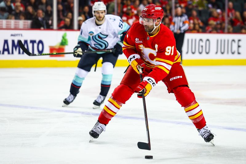 Dec 18, 2025; Calgary, Alberta, CAN; Calgary Flames center Nazem Kadri (91) controls the puck against the Seattle Kraken during the second period at Scotiabank Saddledome. Mandatory Credit: Sergei Belski-Imagn Images