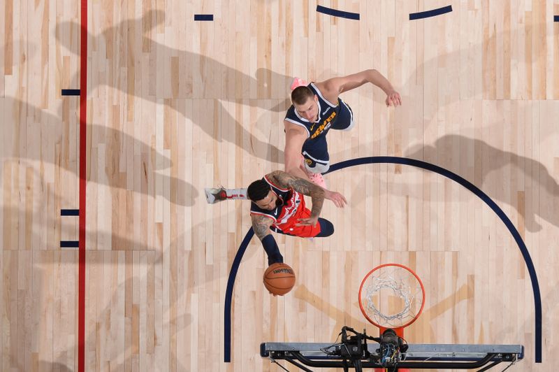 DENVER, CO - FEBRUARY 22: Kyle Kuzma #33 of the Washington Wizards drives to the basket against Nikola Jokic #15 of the Denver Nuggets during the game on February 22, 2024 at the Ball Arena in Denver, Colorado. NOTE TO USER: User expressly acknowledges and agrees that, by downloading and/or using this Photograph, user is consenting to the terms and conditions of the Getty Images License Agreement. Mandatory Copyright Notice: Copyright 2024 NBAE (Photo by Bart Young/NBAE via Getty Images)