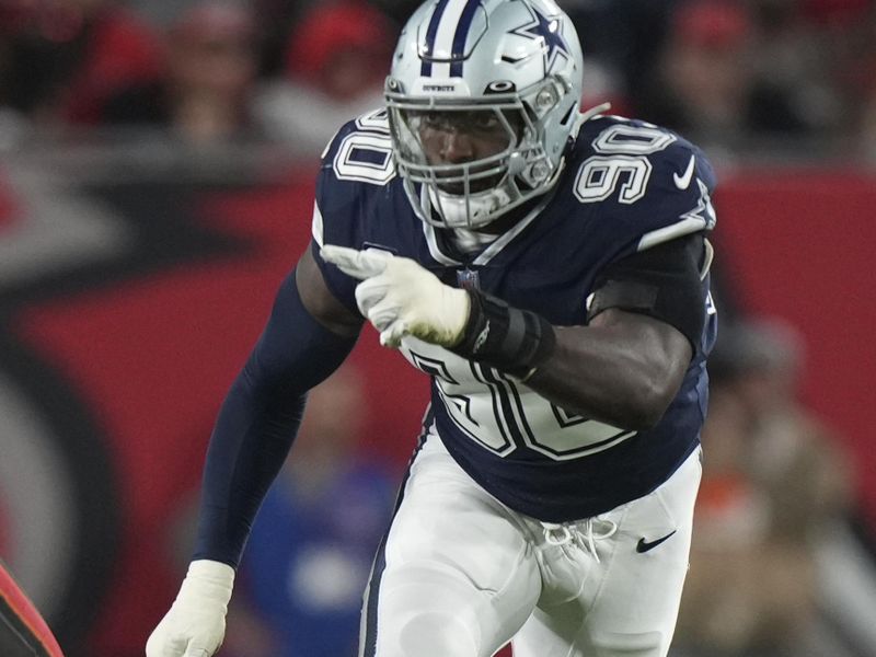 Dallas Cowboys defensive end DeMarcus Lawrence (90) rushes the passer during an NFL wild-card football game against the Tampa Bay Buccaneers, Monday, Jan. 16, 2023, in Tampa, Fla. (AP Photo/Peter Joneleit)