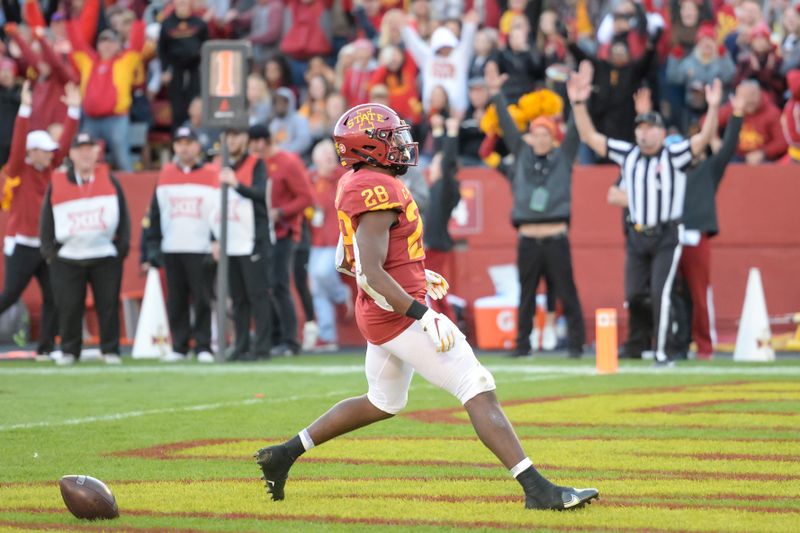 Oct 23, 2021; Ames, Iowa, USA;  Iowa State Cyclones running back Breece Hall (28) scores the winning touchdown against the Oklahoma State Cowboys in the second half at Jack Trice Stadium. Mandatory Credit: Steven Branscombe-USA TODAY Sports