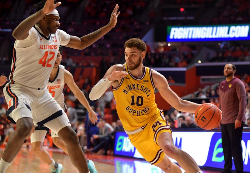 Feb 20, 2023; Champaign, Illinois, USA;  Minnesota Golden Gophers forward Jamison Battle (10) moves the ball past Illinois Fighting Illini forward Dain Dainja (42) during the second half at State Farm Center. Mandatory Credit: Ron Johnson-USA TODAY Sports