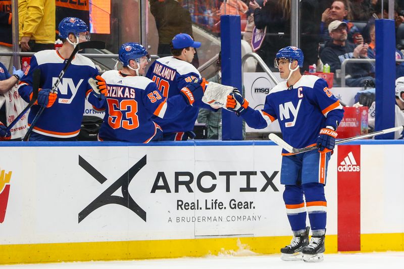 Feb 24, 2024; Elmont, New York, USA;  New York Islanders left wing Anders Lee (27) celebrates with his teammates after scoring a goal in the third period against the Tampa Bay Lightning at UBS Arena. Mandatory Credit: Wendell Cruz-USA TODAY Sports