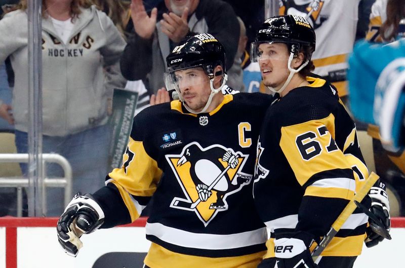 Jan 28, 2023; Pittsburgh, Pennsylvania, USA; Pittsburgh Penguins center Sidney Crosby (87) celebrates his power play goal with right wing Rickard Rakell (67) against the San Jose Sharks during the first period at PPG Paints Arena. Mandatory Credit: Charles LeClaire-USA TODAY Sports