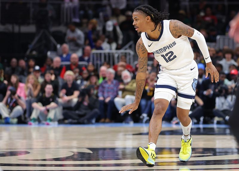 ATLANTA, GEORGIA - DECEMBER 23:  Ja Morant #12 of the Memphis Grizzlies reacts after shooting over Trae Young #11 of the Atlanta Hawks during the fourth quarter at State Farm Arena on December 23, 2023 in Atlanta, Georgia.  NOTE TO USER: User expressly acknowledges and agrees that, by downloading and/or using this photograph, user is consenting to the terms and conditions of the Getty Images License Agreement. (Photo by Kevin C. Cox/Getty Images)