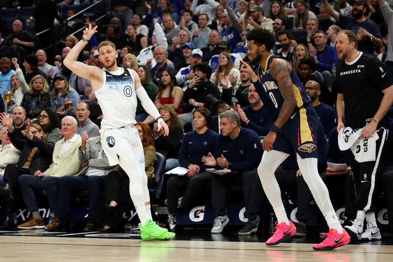 MINNEAPOLIS, MINNESOTA - MARCH 21: Donte DiVincenzo #0 of the Minnesota Timberwolves celebrates his three-point basket as Keion Brooks Jr. #0 of the New Orleans Pelicans reacts in the third quarter at Target Center on March 21, 2025 in Minneapolis, Minnesota. The Timberwolves defeated the Pelicans 134-93. NOTE TO USER: User expressly acknowledges and agrees that, by downloading and or using this photograph, User is consenting to the terms and conditions of the Getty Images License Agreement. (Photo by David Berding/Getty Images)