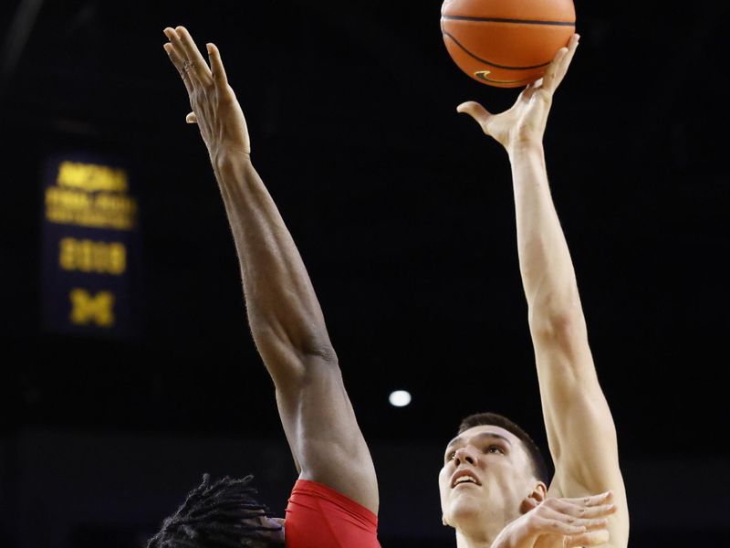 Feb 27, 2025; Ann Arbor, Michigan, USA;  Michigan Wolverines center Vladislav Goldin (50) shoots the ball against Rutgers Scarlet Knights center Emmanuel Ogbole (21) in the first half at Crisler Center. Mandatory Credit: Rick Osentoski-Imagn Images