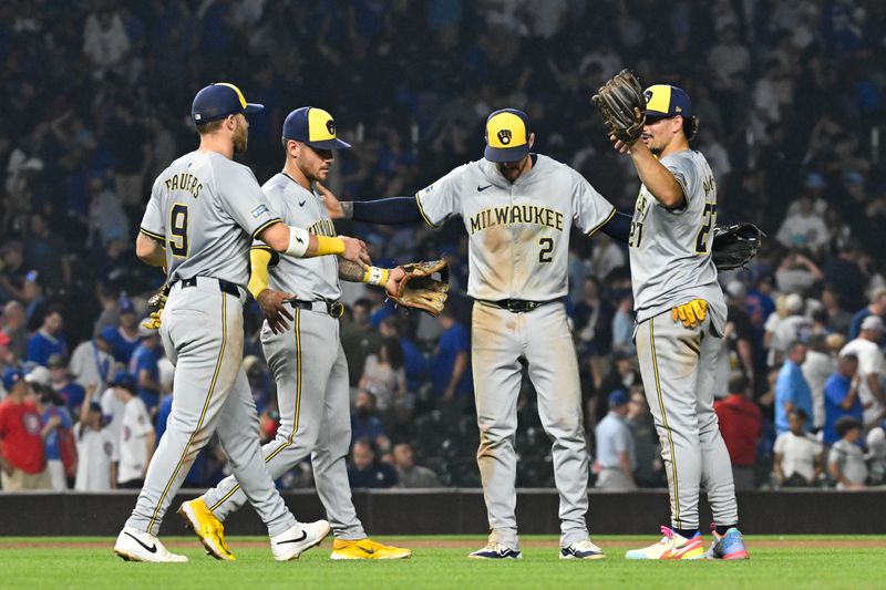 Jul 23, 2024; Chicago, Illinois, USA;  Milwaukee Brewers second baseman Brice Turang (2) reacts with first baseman Jake Bauers (9),  third baseman Joey Ortiz (3) and  shortstop Willy Adames (27) after the game against the Chicago Cubs at Wrigley Field. Mandatory Credit: Matt Marton-USA TODAY Sports