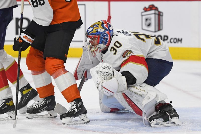 Dec 5, 2024; Philadelphia, Pennsylvania, USA; Florida Panthers goaltender Spencer Knight (30) looks for the puck against the Philadelphia Flyers during the first period at Wells Fargo Center. Mandatory Credit: Eric Hartline-Imagn Images