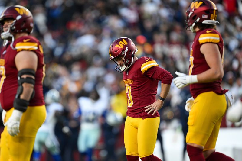 Washington Commanders place kicker Austin Seibert (3) reacts to missing an extra point field goal during the second half of an NFL football game against the Dallas Cowboys, Sunday, Nov. 24, 2024, in Landover, Md. (AP Photo/Terrance Williams)