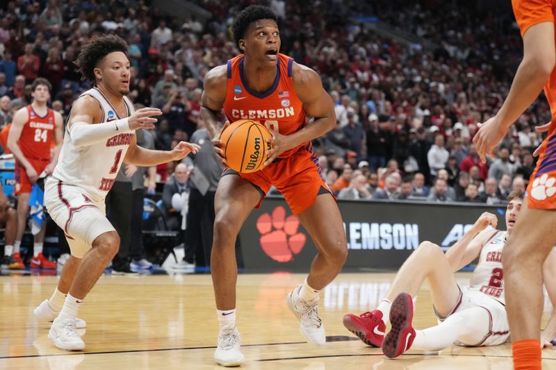 Mar 30, 2024; Los Angeles, CA, USA; Clemson Tigers forward RJ Godfrey (10) controls the ball against Alabama Crimson Tide guard Mark Sears (1) in the second half in the finals of the West Regional of the 2024 NCAA Tournament at Crypto.com Arena. Mandatory Credit: Kirby Lee-USA TODAY Sports