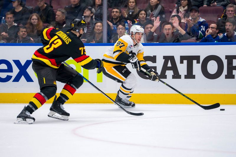 Oct 26, 2024; Vancouver, British Columbia, CAN; Pittsburgh Penguins forward Sidney Crosby (87) drives past Vancouver Canucks defenseman Vincent Desharnais (73) during the second period at Rogers Arena. Mandatory Credit: Bob Frid-Imagn Images