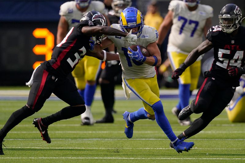 Los Angeles Rams wide receiver Cooper Kupp fumbles the ball as he is hit by Atlanta Falcons cornerback Darren Hall during the second half of an NFL football game Sunday, Sept. 18, 2022, in Inglewood, Calif. (AP Photo/Mark J. Terrill)