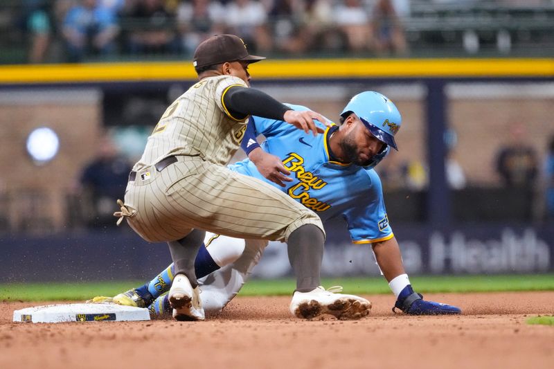 Jun 6, 2025; Milwaukee, Wisconsin, USA;  Milwaukee Brewers center fielder Jackson Chourio (11) steals second base before San Diego Padres shortstop Xander Bogaerts (2) can apply the tag during the seventh inning at American Family Field. Mandatory Credit: Jeff Hanisch-Imagn Images