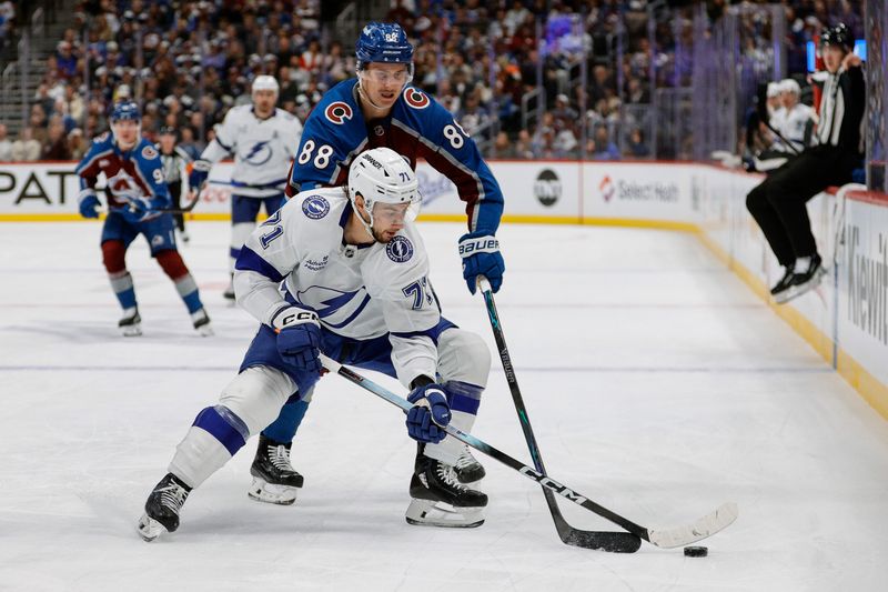 Nov 4, 2025; Denver, Colorado, USA; Tampa Bay Lightning center Anthony Cirelli (71) controls the puck under pressure from Colorado Avalanche center Martin Necas (88) in the first period at Ball Arena. Mandatory Credit: Isaiah J. Downing-Imagn Images